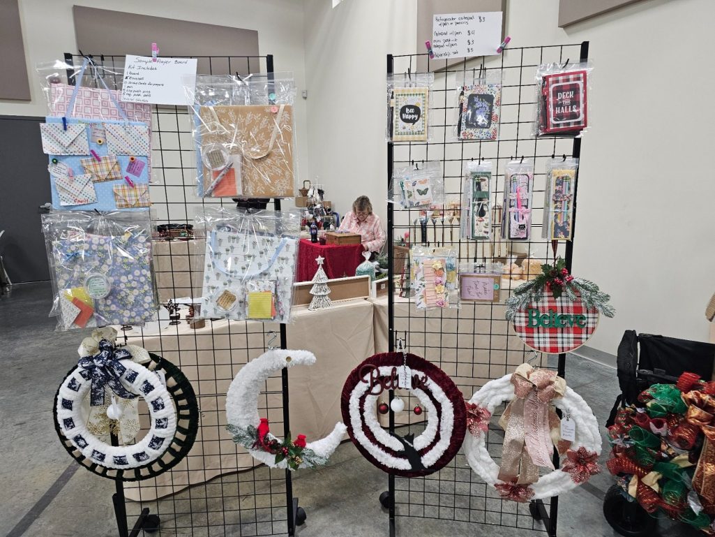 Craft fair display featuring decorative wreaths and handmade art.